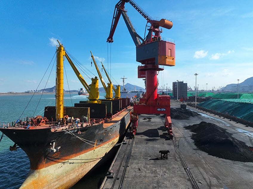 A cargo ship is unloading a batch of electric coal at the Port coal terminal in Lianyungang, China, on January 22, 2024. (Photo by Costfoto/NurPhoto via Getty Images)