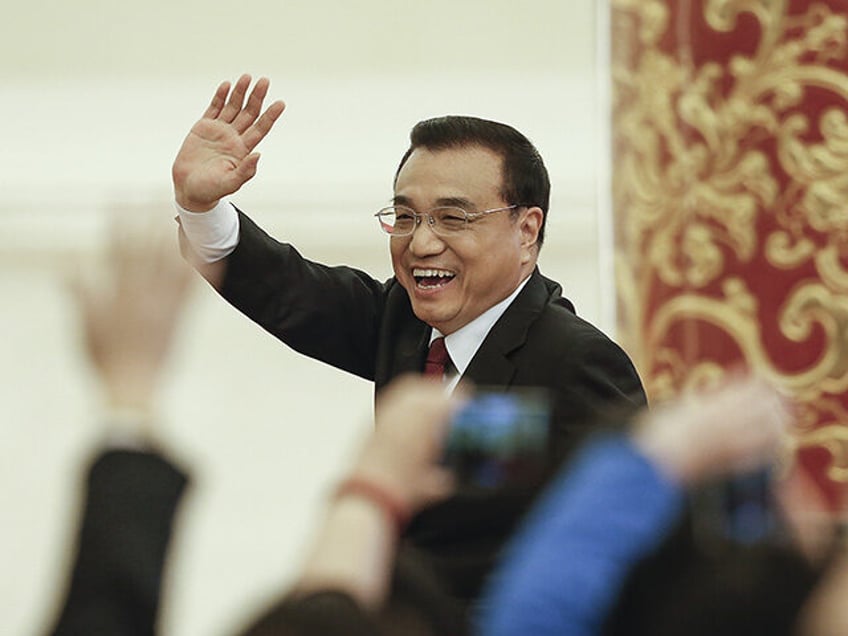 China's Premier Li Keqiang waves as leaving the annual news conference following the closi