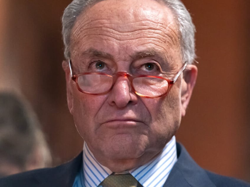 WASHINGTON, DC - DECEMBER 6: U.S. Senate Majority Leader Chuck Schumer (D-NY) listens as g