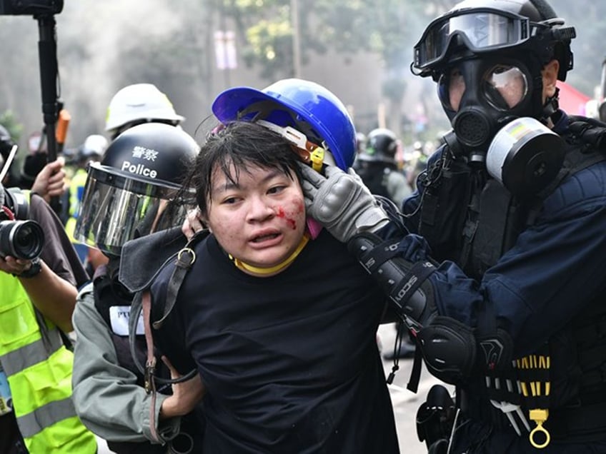 TOPSHOT - Protesters are detained by police near the Hong Kong Polytechnic University in Hung Hom district of Hong Kong on November 18, 2019. - Pro-democracy demonstrators holed up in a Hong Kong university campus set the main entrance ablaze on November 18 to prevent surrounding police moving in, after officers warned they may use live rounds if confronted by deadly weapons. (Photo by Anthony WALLACE / AFP) (Photo by ANTHONY WALLACE/AFP via Getty Images)