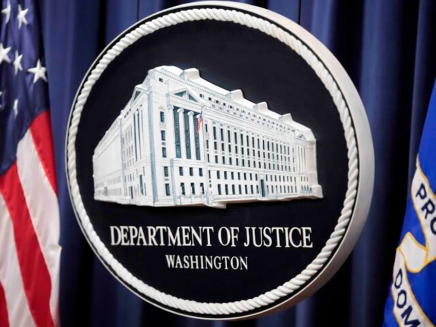 FILE - The logo for the Justice Department is seen before a news conference at the Departm