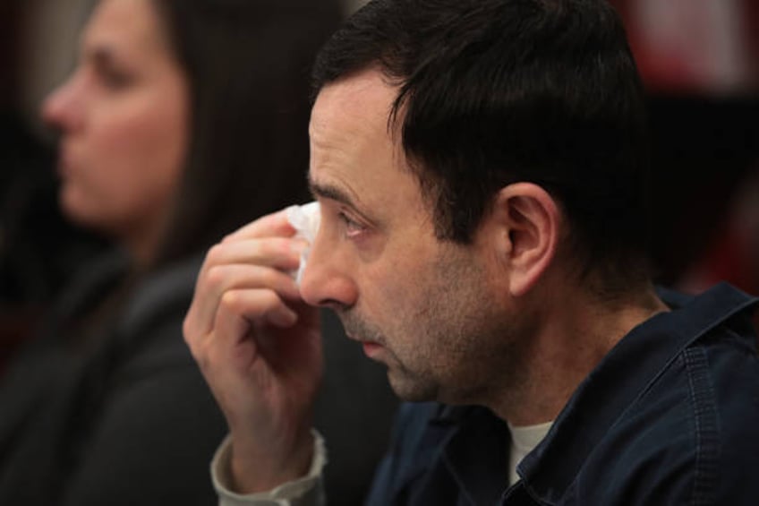 Larry Nassar wipes a tear as he listens to Carrie Hogan deliver a victim impact statement at his sentencing hearing on January 17, 2018 in Lansing,...