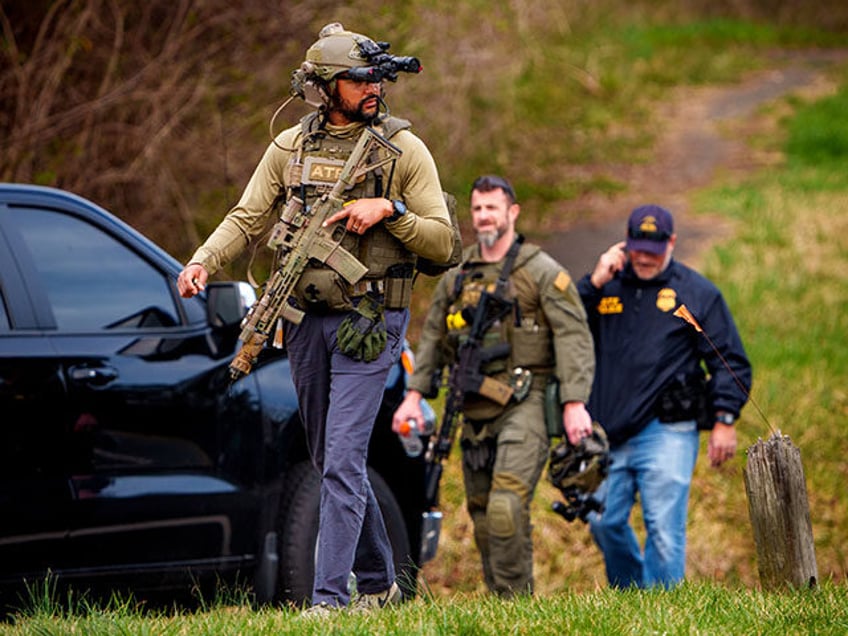 ATF officers depart after law enforcement took an unidentified man into custody following