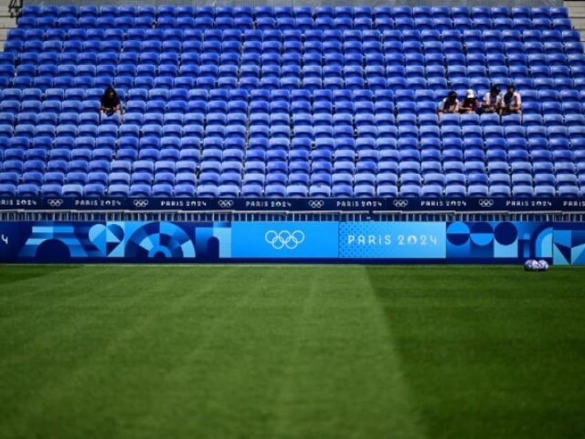 Football fans sit in empty tribunes prior to the women's group A football match betw