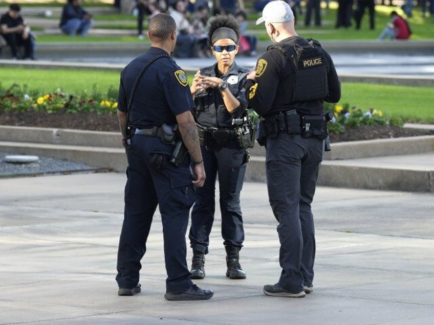 Houston Police officers watch over displaced church goers outside Lakewood Church on Sunda