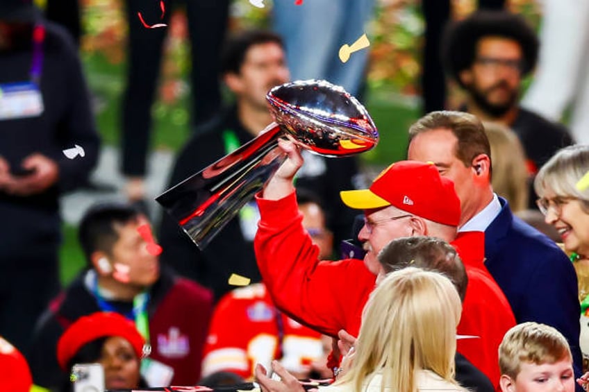 Kansas City Chiefs head coach raises the Lombardi trophy after Super Bowl LVIII between the Kansas City Chiefs and the San Francisco 49ers on Sunday...