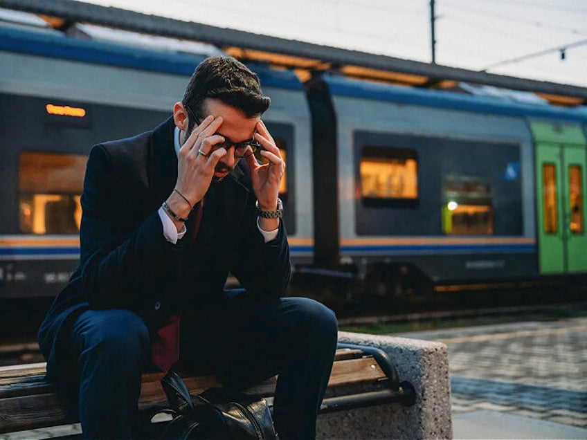 A young businessman is tired after a day at work - stock photo