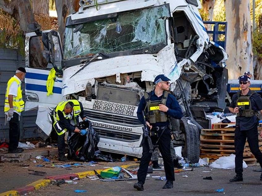 Israeli police and rescue services inspect the site where a truck driver rammed into a bus