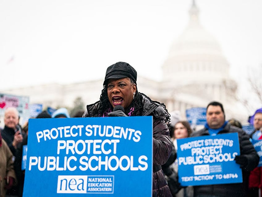 Becky Pringle, president of the National Education Association, speaks during a protest ag