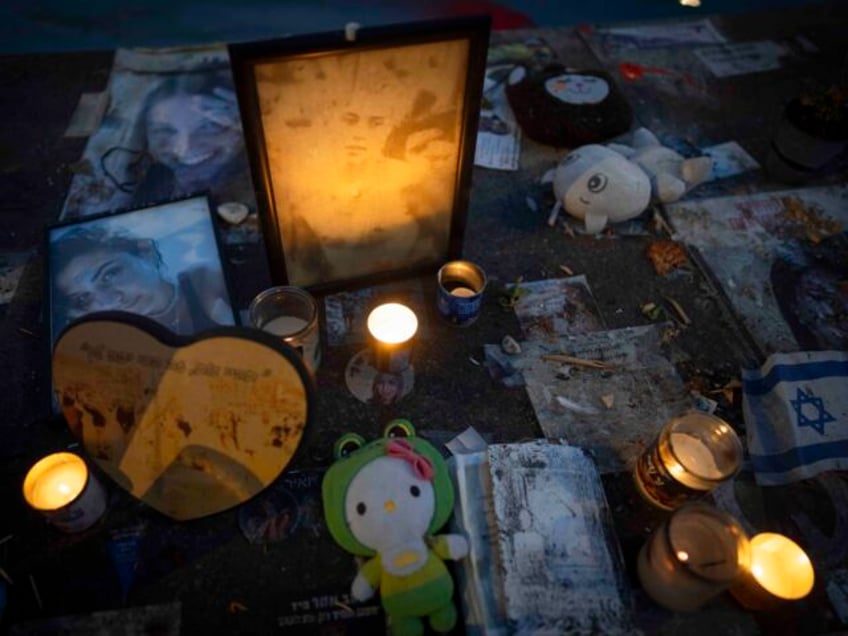 Candles are lit in a memorial to mark one year in the Hebrew calendar since the Hamas cros