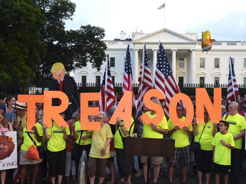 Members of the Herndon-Reston Indivisible group take part in the #KremlinAnnex singing pro