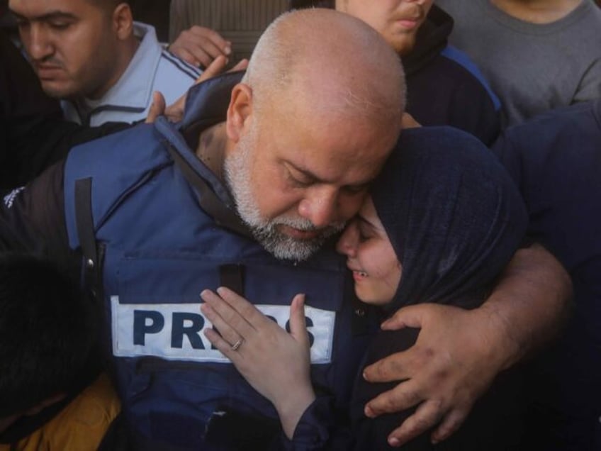 07 January 2024, Palestinian Territories, Rafah: Wael Dahdouh, Al-Jazeera bureau chief in Gaza, comforts a family member as they mourn over the body of his dead son Hamza, who also worked as a journalist for Al Jazeera and was killed in an Israeli air strike on Rafah. Dahdouh has previously …