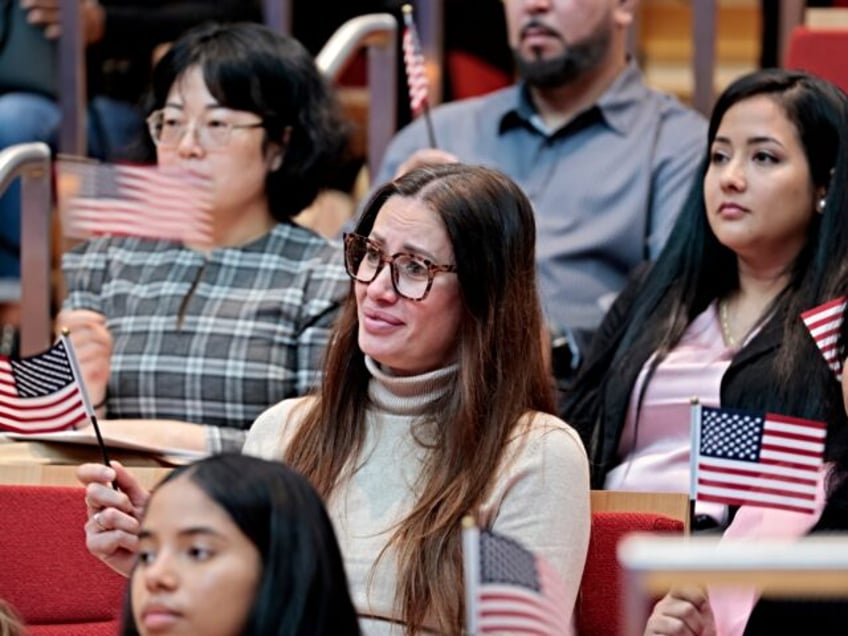 Boston, MA - October 31: New citizens waved their flags, as America the Beautiful is being