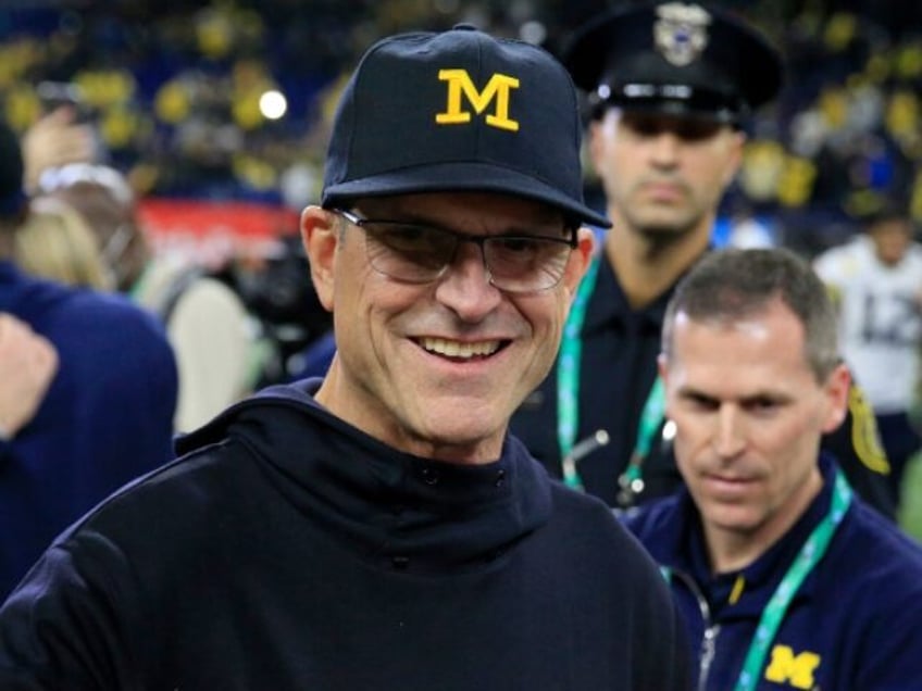 report jim harbaugh to receive credit for wins despite suspension