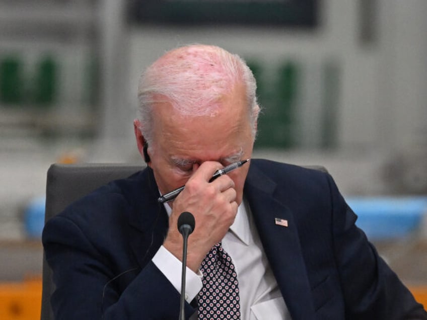 US President Joe Biden reacts while attending the Lobito Corridor Trans-Africa Summit at t