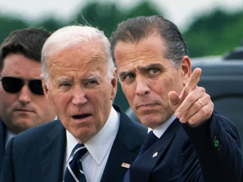 President Joe Biden talks with his son Hunter Biden as he arrives Delaware Air National Gu