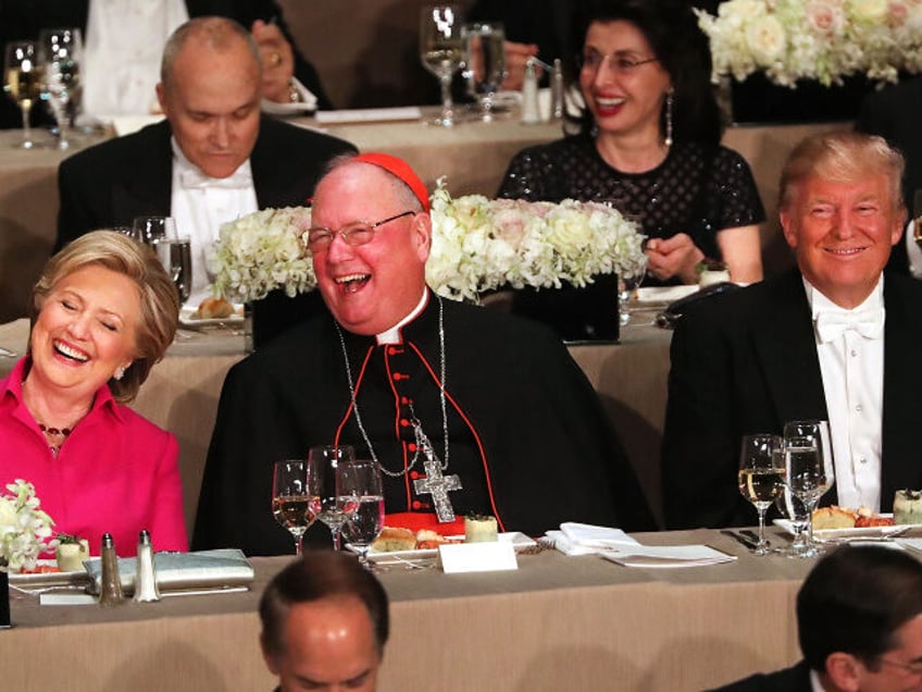 Cardinal Timothy Dolan sits between, Hillary Clinton and Donald Trump attend the annual Al