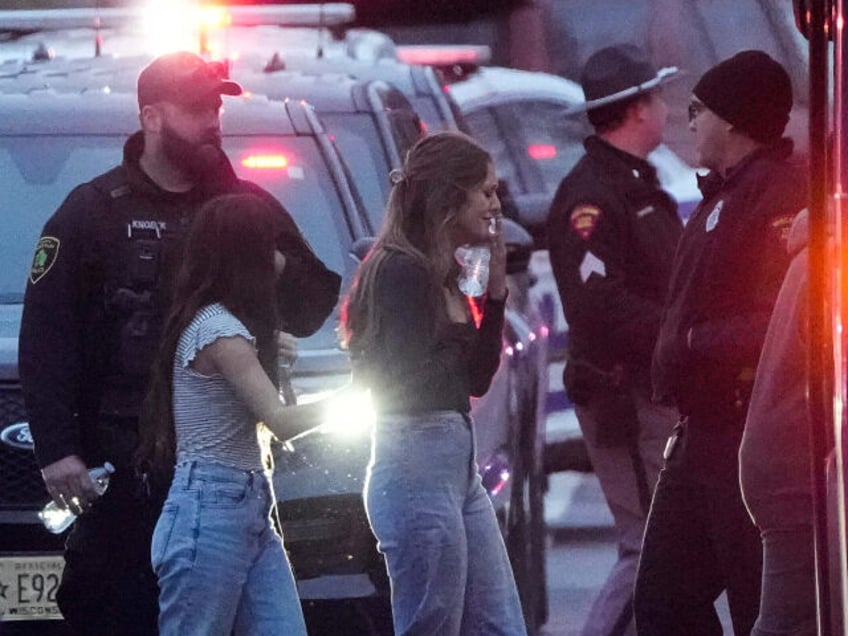 Students board a bus as they leave the shelter following a shooting at the Abundant Life C