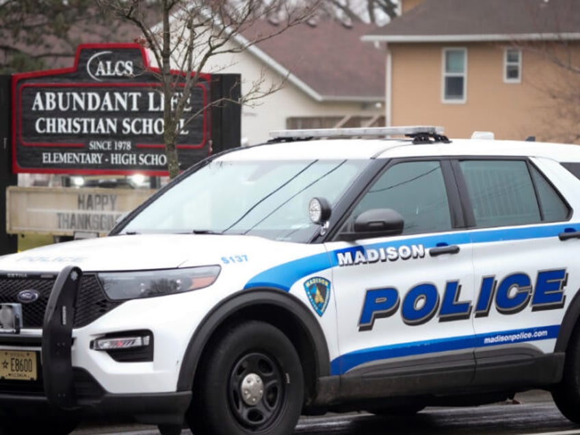 Emergency vehicles are parked outside the Abundant Life Christian School in Madison, Wis.,