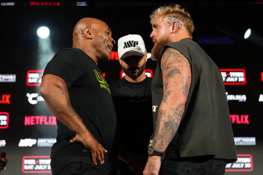 Mike Tyson, Nakisa Bidarian and Jake Paul pose onstage during the Jake Paul vs. Mike Tyson Boxing match Arlington press conference at Texas Live! on...