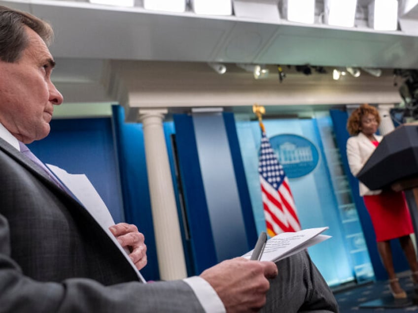 National Security Council spokesman John Kirby, left, sits near White House press secretar