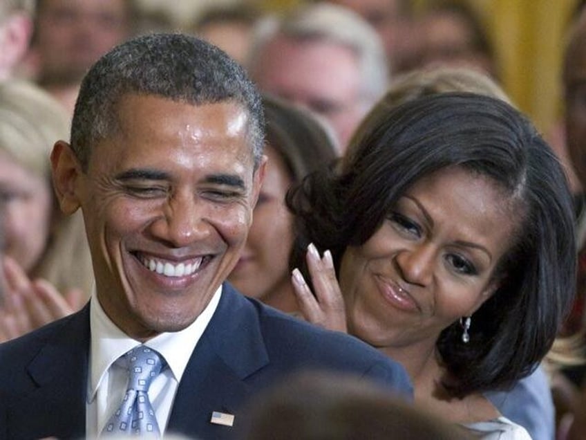 President Barack Obama and first lady Michelle Obama applaud former President George H.W. Bush and former first lady Barbara Bush, not seen, during the portrait unveiling ceremony for former President George W. Bush and former first lady Laura Bush portraits, May 31, 2012, in the East Room of the White …