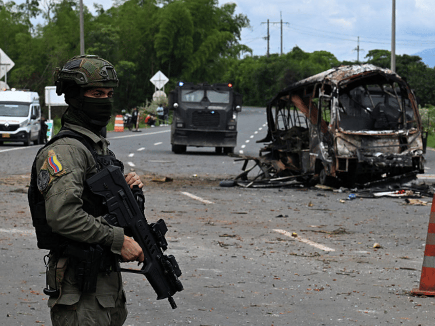 TOPSHOT - A police officer stands guard at the site where a bus exploded in front of a pol