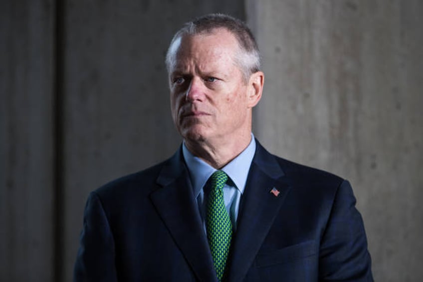 Massachusetts Governor Charlie Baker listens as Mayor Marty Walsh speaks at a press conference announcing the postponement of the Boston Marathon to...