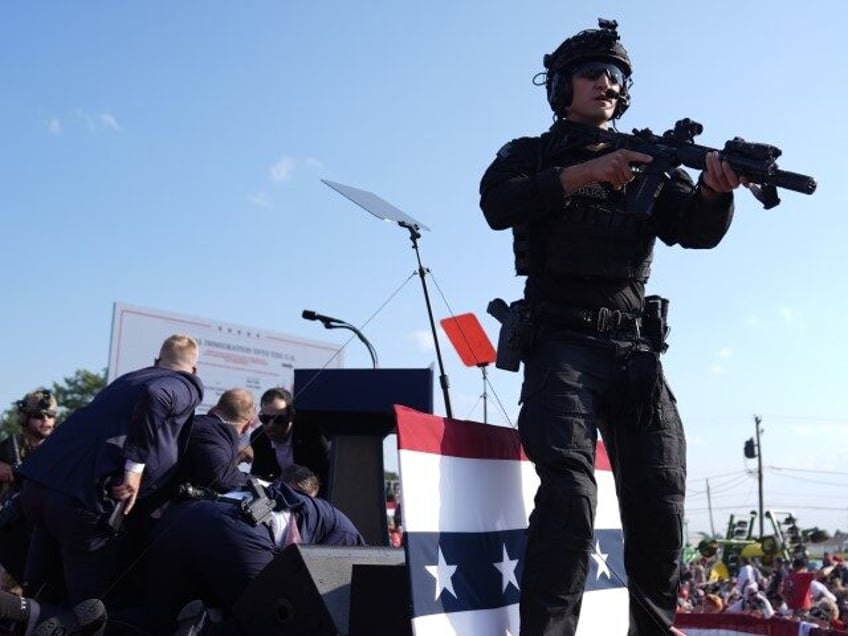 Republican presidential candidate former President Donald Trump is surrounded by U.S. Secr