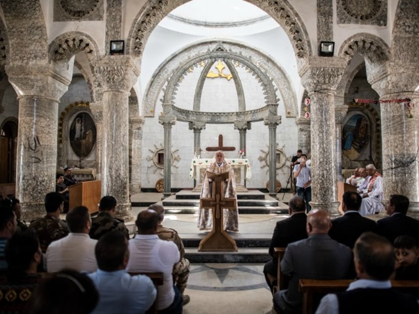 Iraqi Syriac Christian priest Charbel Aesso leads an easter service at Saint John's Church (Mar Yohanna) in the nearly deserted predominantly Christian Iraqi town of Qaraqosh on April 16, 2017 near Mosul, Iraq. Qaraqosh was retaken by Iraqi forces in 2016 during the offensive to capture the nearby city of Mosul from Islamic State but it remains almost completely deserted. (Photo by Carl Court/Getty Images)