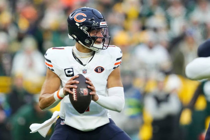 Justin Fields of the Chicago Bears looks to throw a pass in the first half against the Green Bay Packers at Lambeau Field on January 07, 2024 in...
