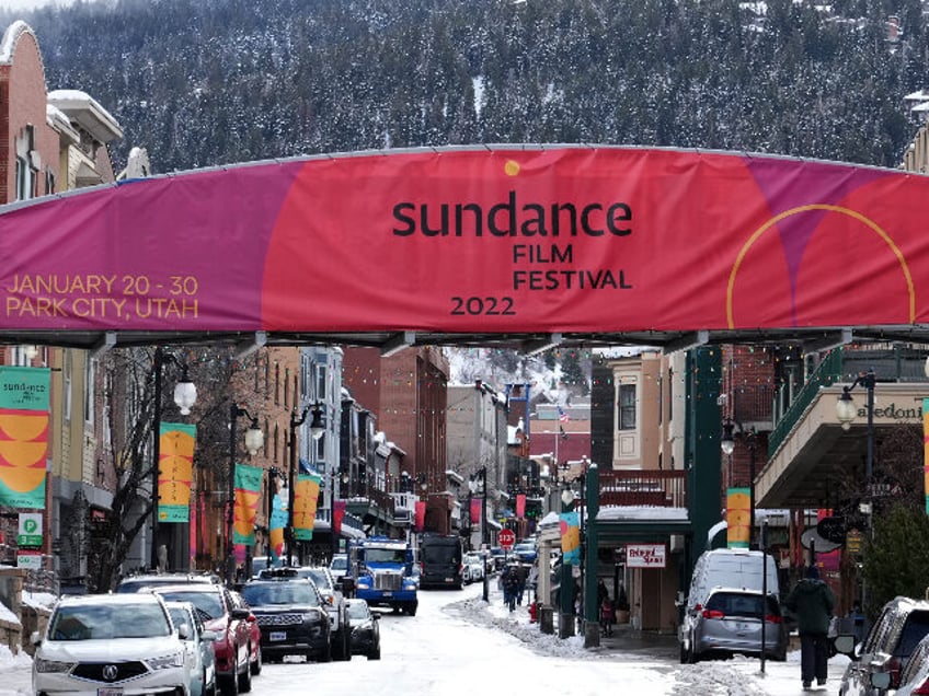 PARK CITY, UT - January 6: People and cars walk and drive up and down Old Main Street wher