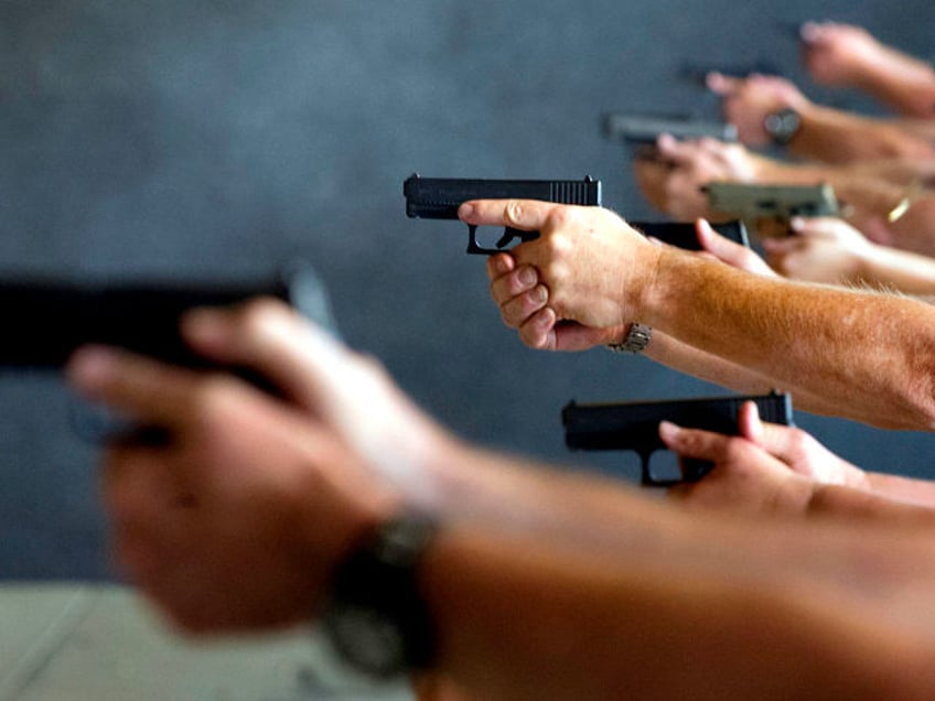 School teachers and administrators fire their guns during a three-day firearms course sponsored by FASTER Colorado at Flatrock Training Center in Commerce City, Colorado on June 27, 2018. - FASTER Colorado has been sponsoring firearms training to Colorado teachers and administrators since 2017. Over 100 Colorado teachers and administrators have …