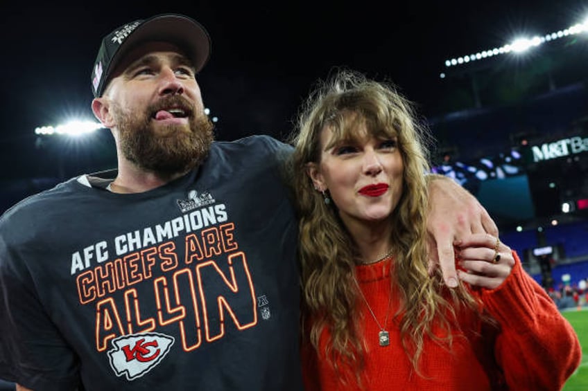 Travis Kelce of the Kansas City Chiefs celebrates with Taylor Swift after defeating the Baltimore Ravens in the AFC Championship Game at M&T Bank...