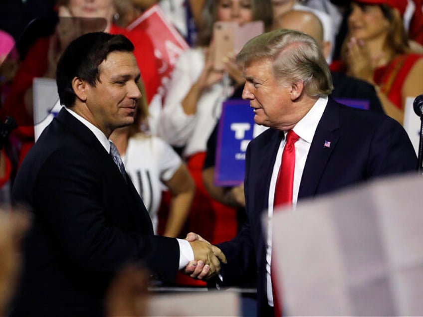 FILE - In this July 31, 2018, file photo, President Donald Trump, right, shakes hands with