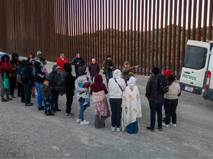 SASABE, ARIZONA - JANUARY 20: Immigrants wait to be transported by U.S. Border Patrol agen