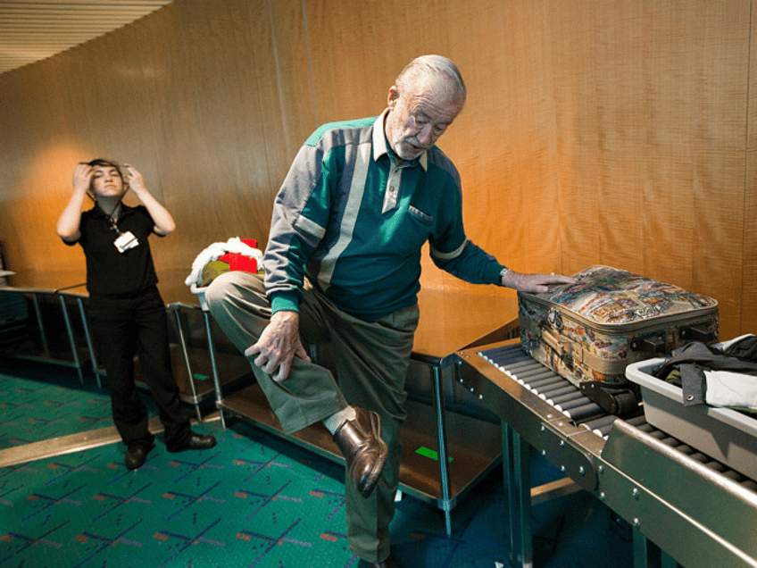 PORTLAND, OR - MARCH 19: Tony Welch leaves his shoes on as he passes through airport secur