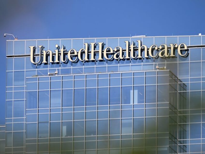 UnitedHealthcare (UHC) health insurance company signage is displayed on an office building