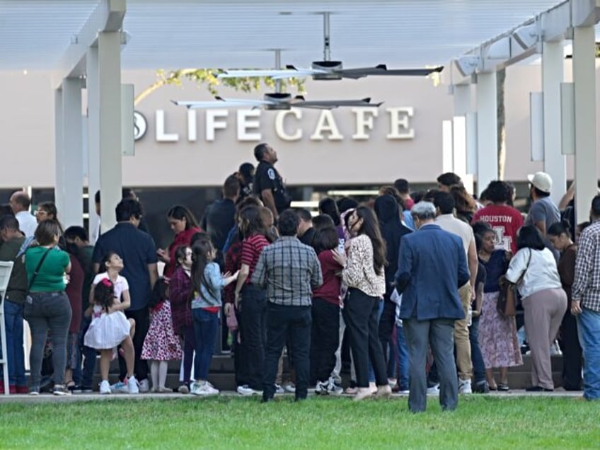 HOUSTON, TEXAS - FEBRUARY 11: People listen to Houston Police officers speak in front of t