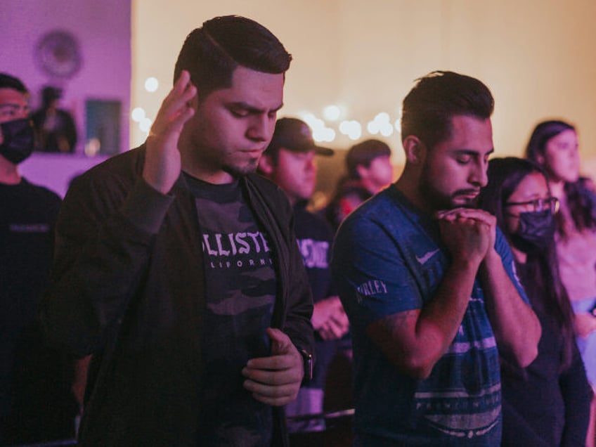 Christian worship a-group-of-people-standing-in-a-room