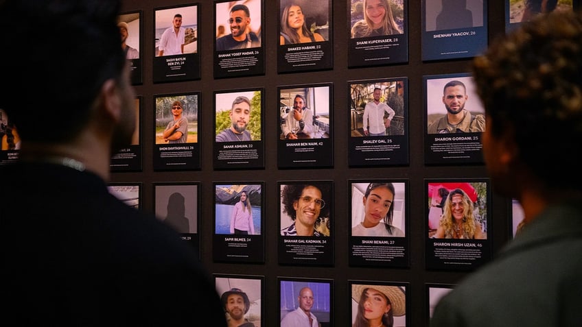 Reef Peretz, Chairman of the Nova Foundation, looks at the names and faces of people killed during the Nova festival at "The Nova Music Festival Exhibition: October 7th 06:29 AM, The Moment Music Stood Still" on April 18, 2024 in New York City.