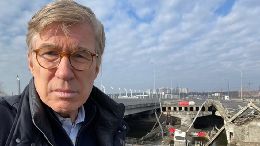 Fox News' Greg Palkot pictured up close, stands in front of Irpin Bridge