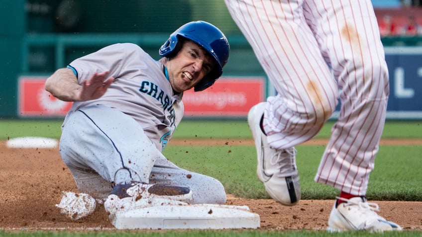 Rep. Jeff Jackson, D-N.C., slides to steal third base in the second inning of the Congressional Baseball Game at National Park in Washington.