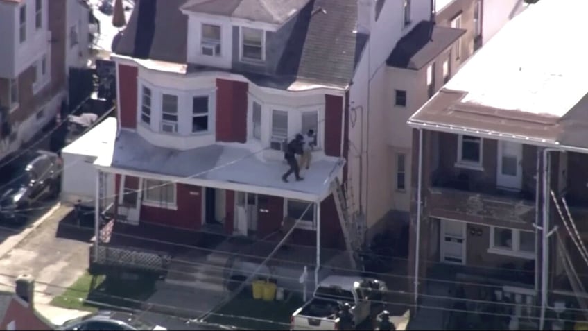 SWAT team attempts to infiltrate residence with Falls Township shooter in Trenton, New Jersey