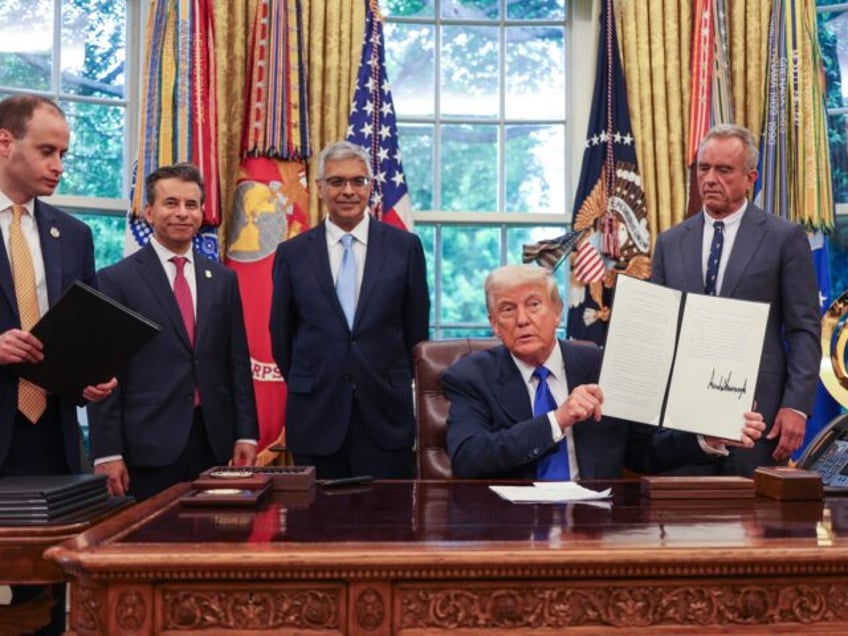 US President Donald Trump speaks to the media while signing executive orders in the Oval O