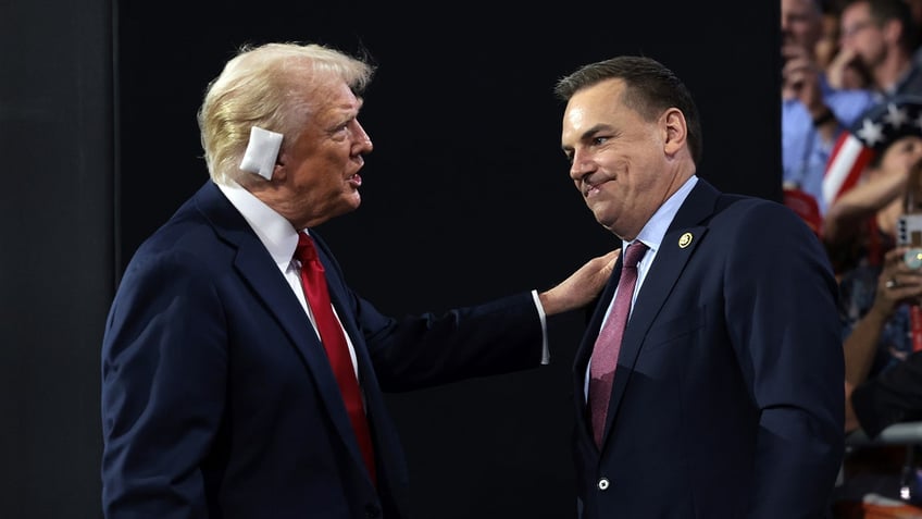 Republican presidential candidate former President Donald Trump, left, greets U.S. Rep. Richard Hudson (R-NC), chair of the National Republican Congressional Committee, on the fourth day of the Republican National Convention at the Fiserv Forum on July 18, 2024 in Milwaukee.