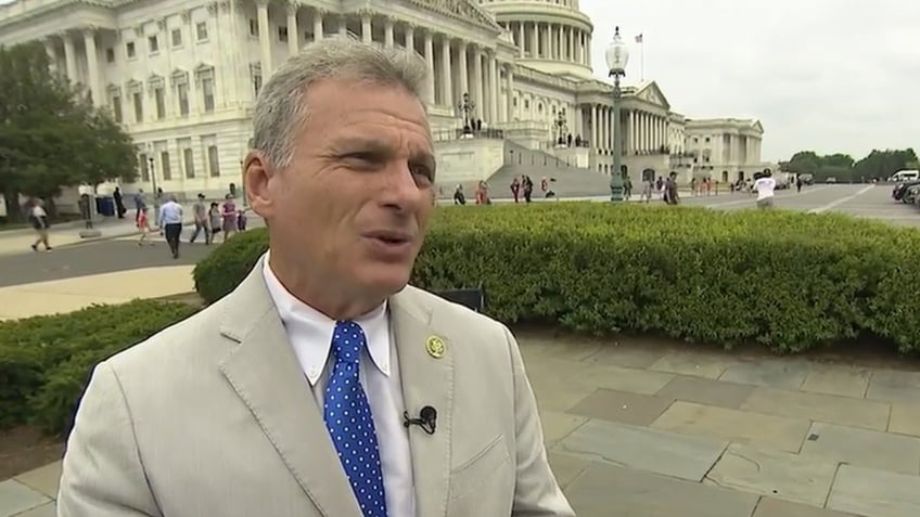 Rep. Buddy Carter in tan suit outside Capitol