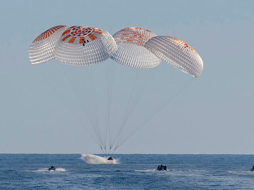 In this image provided by NASA, a SpaceX capsule splashes down in the Gulf of Mexico, Tues