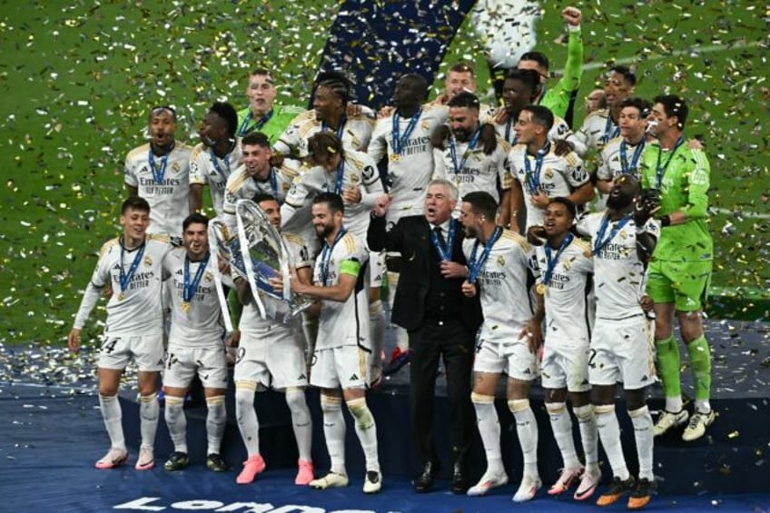 Real Madrid players celebrate with the Champions League trophy after beating Borussia Dort