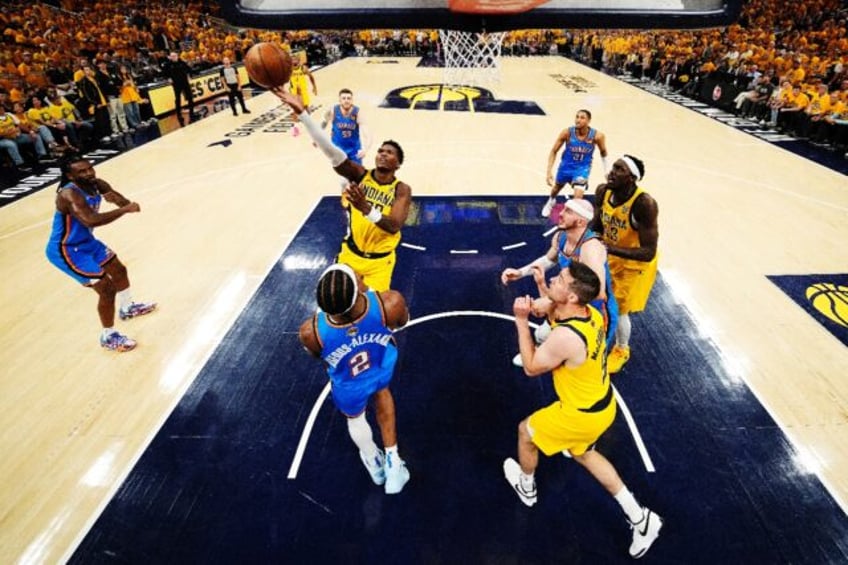 Bennedict Mathurin of the Indiana Pacers shoots the ball over Oklahoma City's Shai Gilgeou